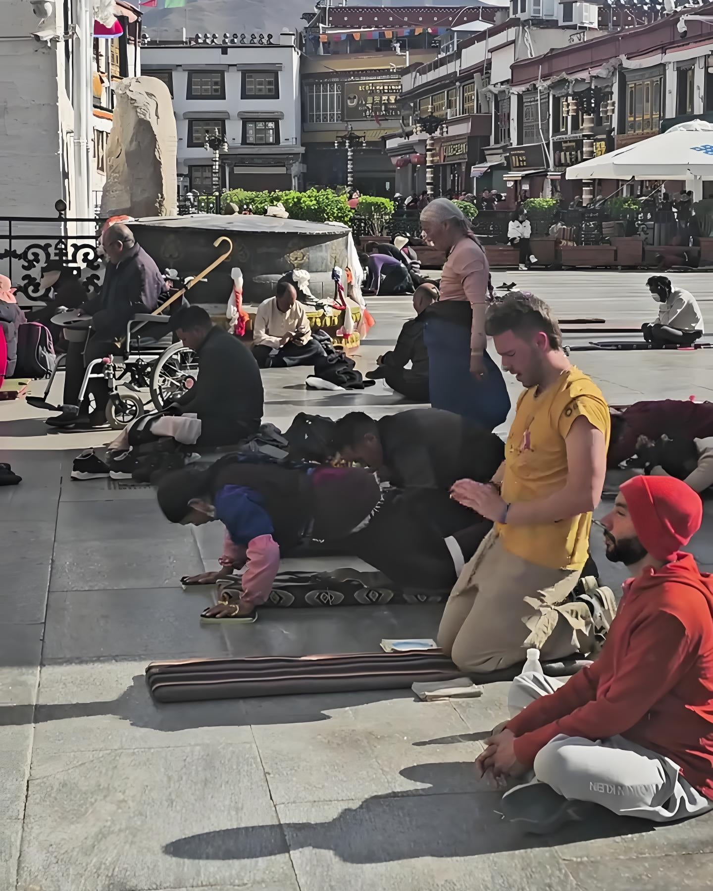 Western devotees pilgrimage image, showing foreign worshippers praying solemnly inside the temple