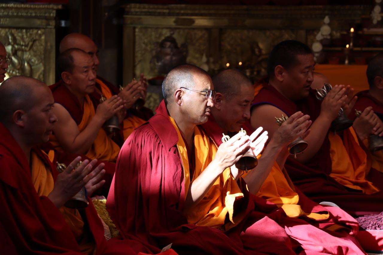 Tibetan Buddhist monk chanting image, showing religious ceremony and devout atmosphere