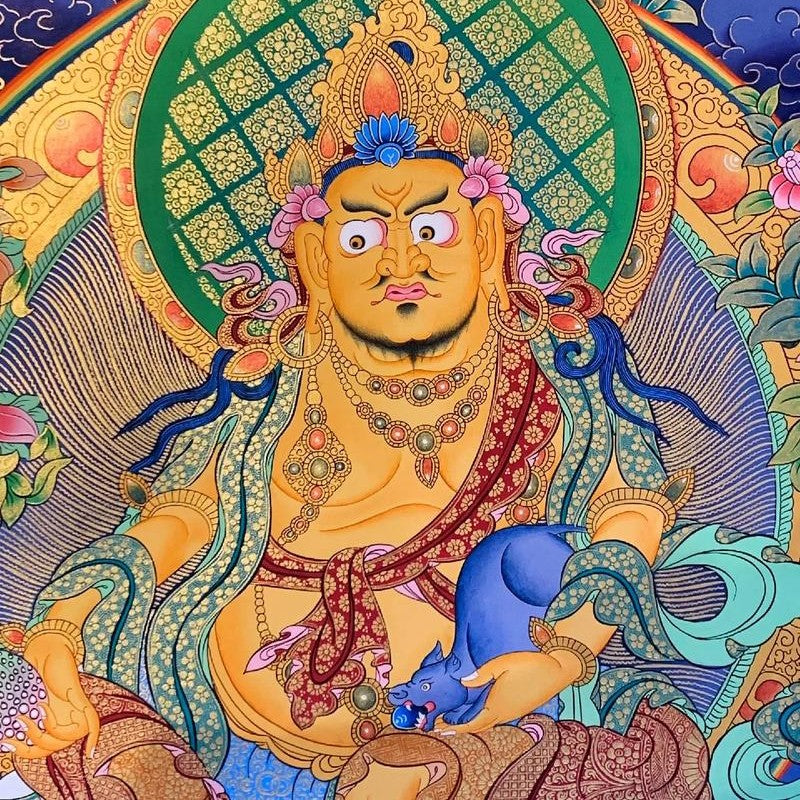 Close-up detail of hand-painted Thangka of Yellow Jambhala, Tibetan Buddhist deity of wealth